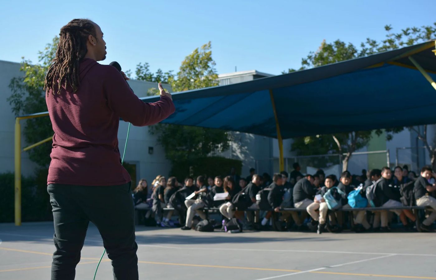 An AIM artist-educator performing for a school audience