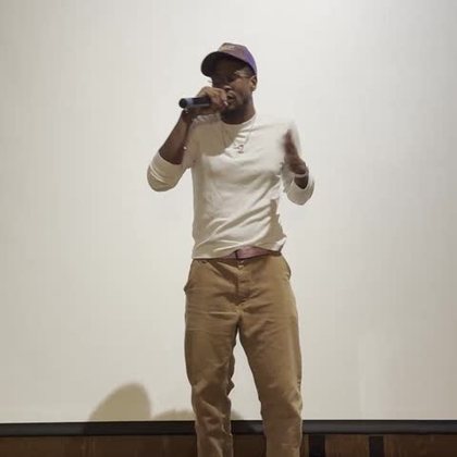 An AIM artist performing with a microphone