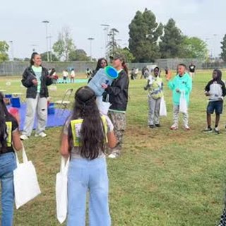 Young people gathered outdoors at an AIM community event