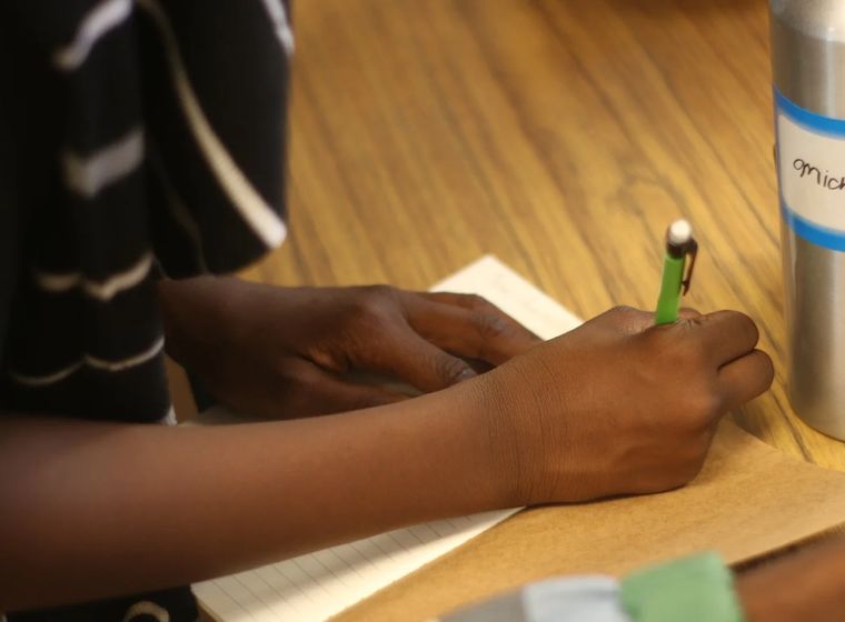 A participant writing during a HeArt Session